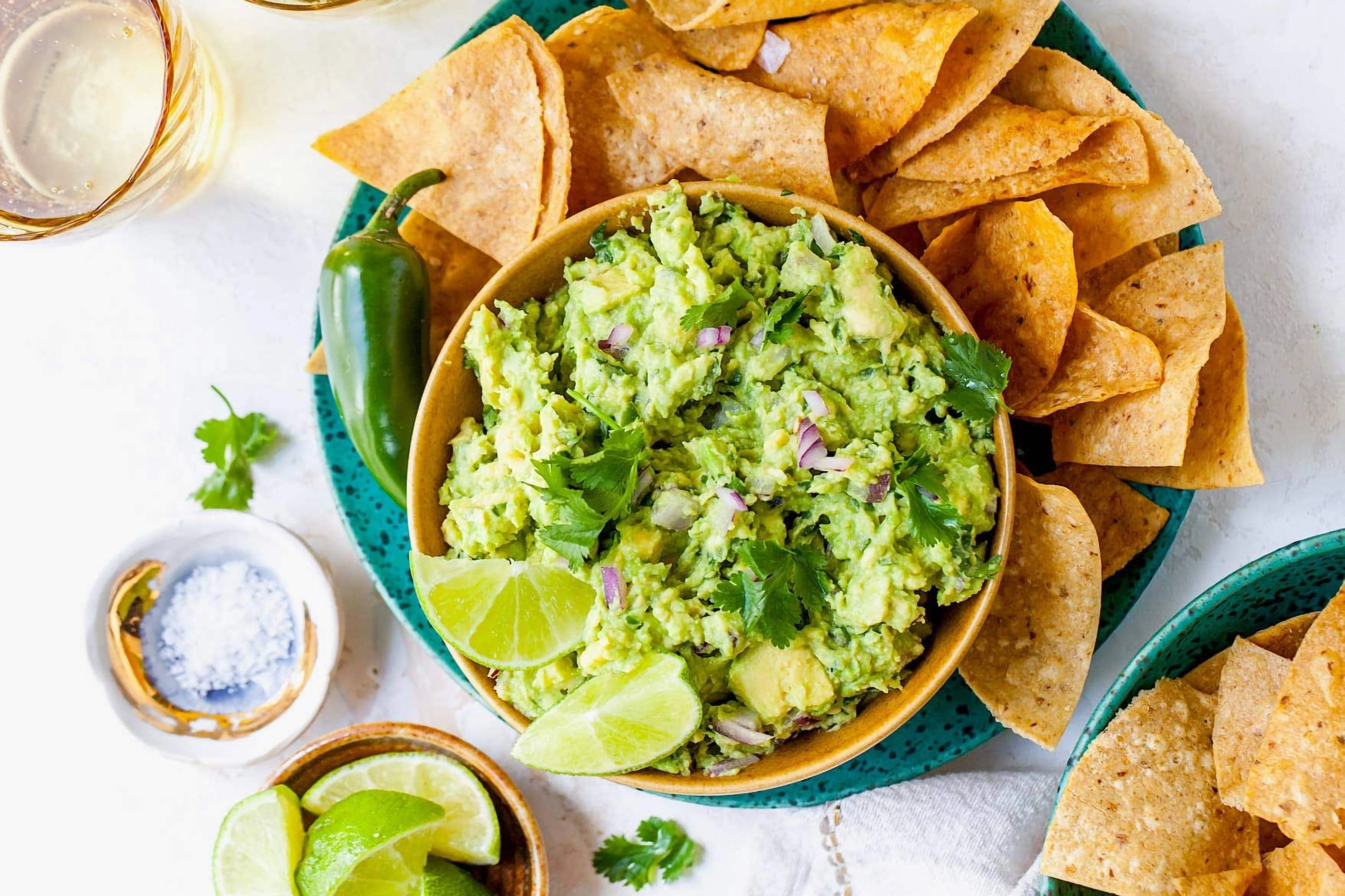 A bowl of guacamole with chips